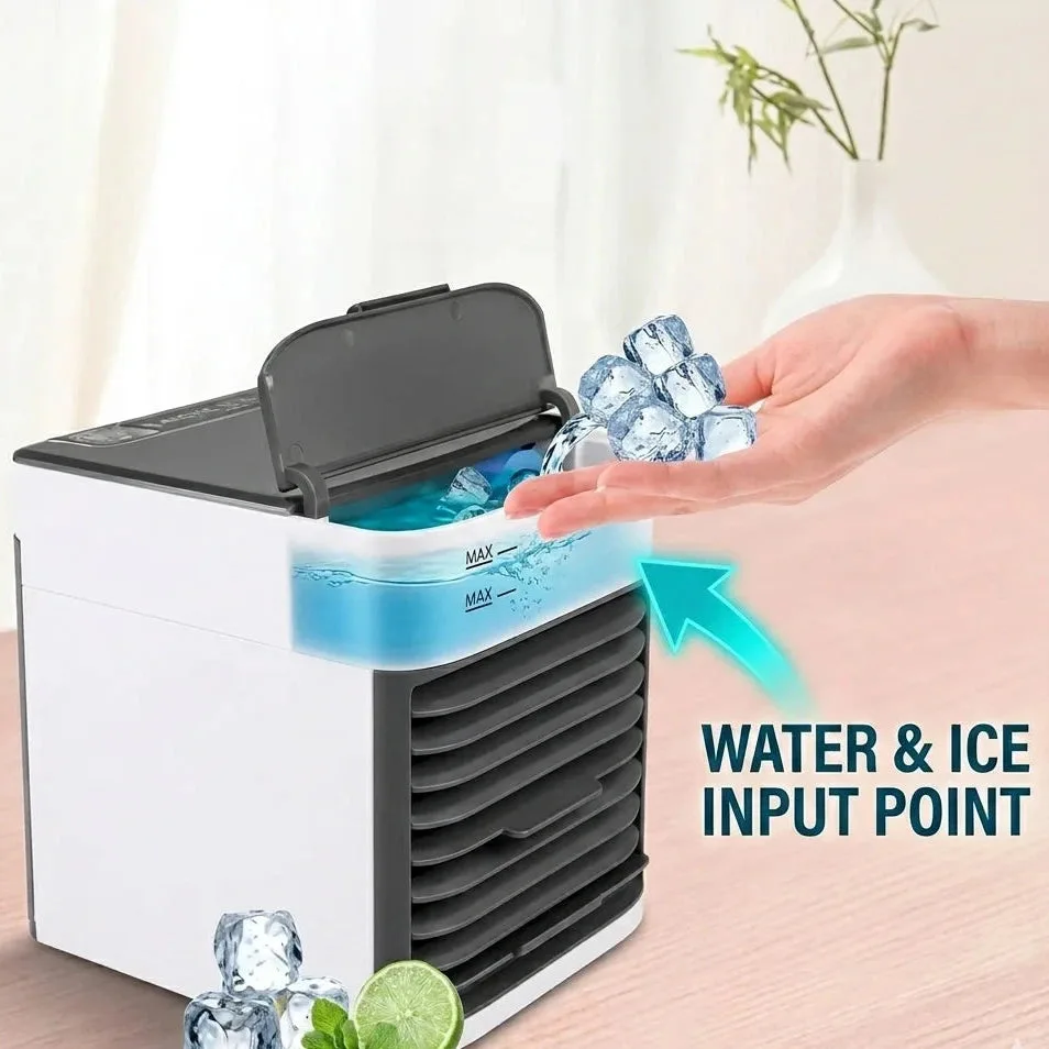 Hand adding ice cubes into the Arctic Air Ultra mini air cooler's flip-top water and ice input point
