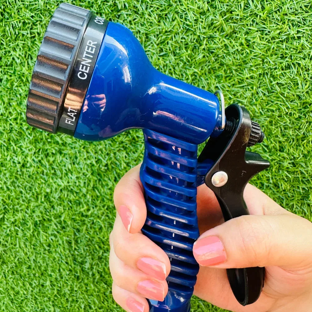 Hand gripping the Expandable Magic Hose's multi-mode spray nozzle set to Center spray pattern