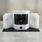 Small white portable heater with black interior on a light gray surface. Mini air cooler pro with 2 water bottles